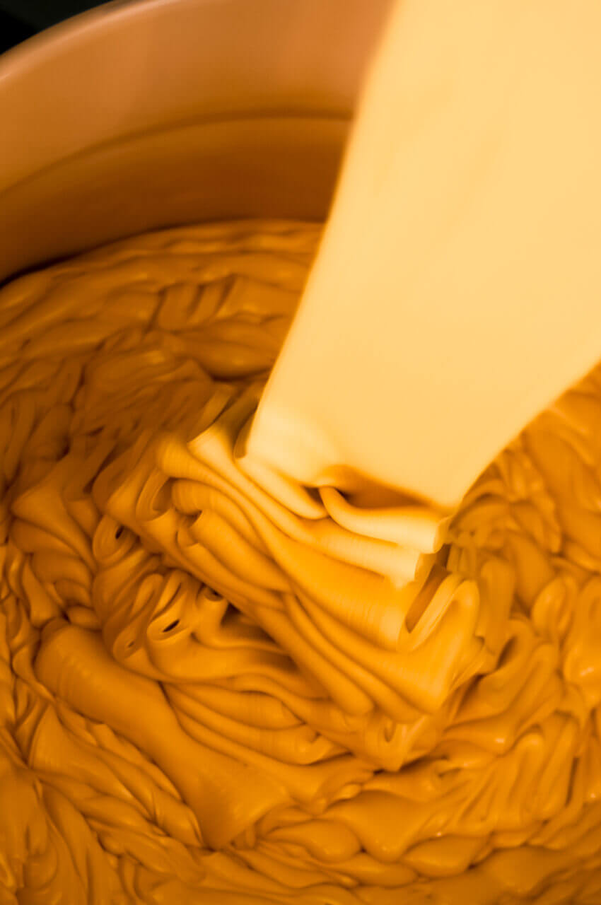 Filling a bucket with water-based extruder primer paint for frames