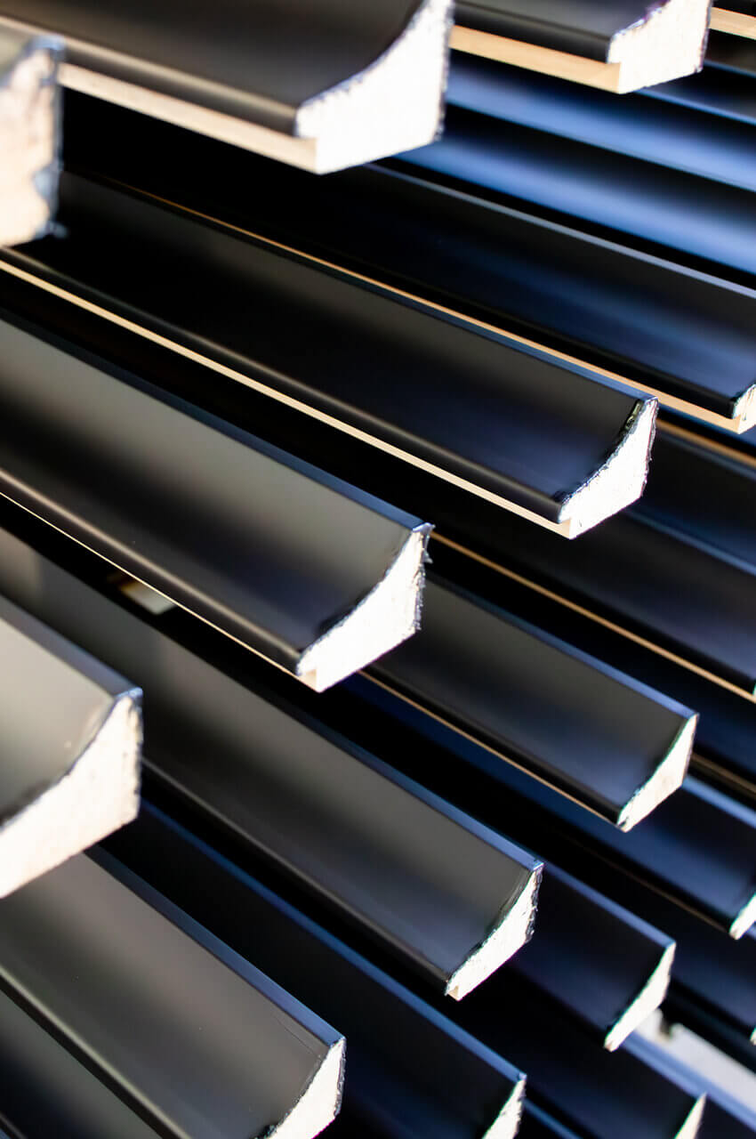 Sections of frames painted with primers applied by extruder
