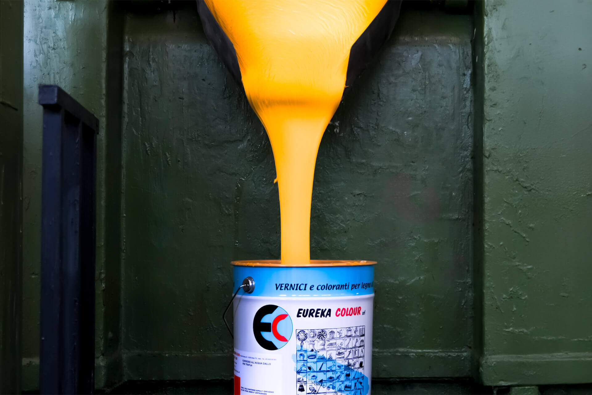 Bucket being filled with yellow coating