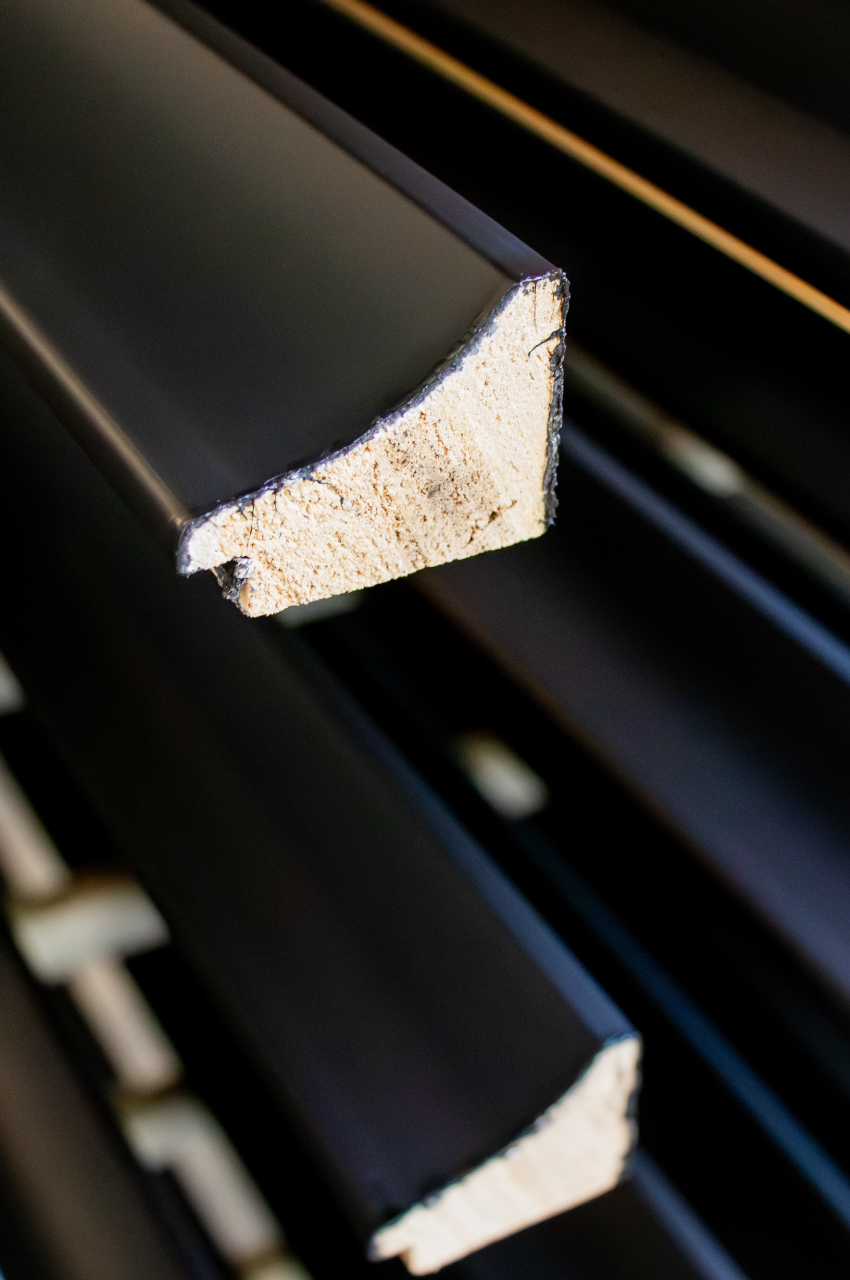 Section of a frame painted with solvent-based extruder primer for frames
